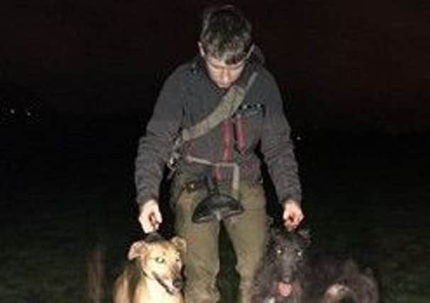 Connor, pictured with two of his dogs.