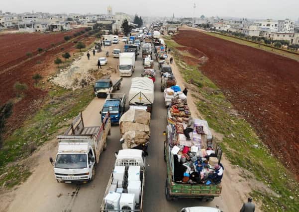 Displaced Syrians driving through Hazano in the northern countryside of Idlib, after fleeing on January 28. Pic:  Getty Images