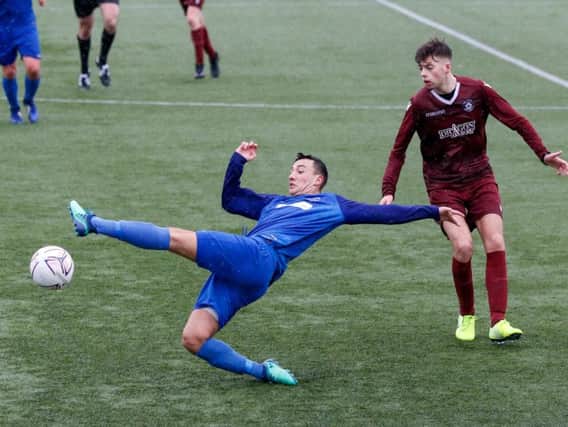 Dylan Duddy of Carluke Rovers makes a sliding challenge against Port Glasgow on Saturday (Pic by Kevin Ramage)