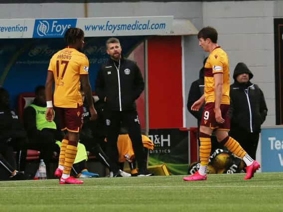 Motherwell manager Stephen Robinson looks none too pleased with Chris Long as the striker walks off after receiving a red card at Hamilton (Pic by Ian McFadyen)